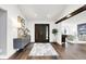 Welcoming foyer with hardwood floors, modern console table and view into living spaces at 3528 E 116Th St, Carmel, IN 46033