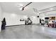 Spacious garage with epoxy floor, ample storage cabinets, and well-lit area, perfect for organization at 3528 E 116Th St, Carmel, IN 46033