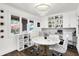 Bright home office space with built-in shelving, a round table, stylish chandelier, and an exterior view at 3528 E 116Th St, Carmel, IN 46033
