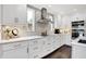 Modern kitchen featuring white cabinets, stainless steel appliances, marble countertops and dark hardwood floors at 3528 E 116Th St, Carmel, IN 46033