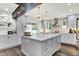 Bright kitchen with a large island, stainless steel appliances, and view to the outdoor living area at 3528 E 116Th St, Carmel, IN 46033