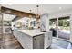 Gourmet kitchen featuring stainless steel appliances, double islands, and access to outdoor patio at 3528 E 116Th St, Carmel, IN 46033