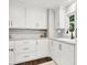 Bright kitchenette featuring ample white cabinetry, marble countertops, and a farmhouse sink at 3528 E 116Th St, Carmel, IN 46033