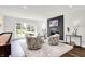 Bright living room featuring modern fireplace, plush seating and large windows offering plentiful natural light at 3528 E 116Th St, Carmel, IN 46033