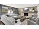 Inviting living room featuring a stone fireplace, large sofa, modern art and neutral color scheme at 3528 E 116Th St, Carmel, IN 46033