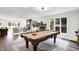 Elegant living room boasts a pool table, baby grand piano, and ample natural light at 3528 E 116Th St, Carmel, IN 46033