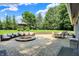Large brick patio featuring comfortable seating area, dining table, and a fire pit at 3528 E 116Th St, Carmel, IN 46033