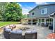 Outdoor patio area with fire pit, outdoor kitchen, seating, and manicured landscaping at 3528 E 116Th St, Carmel, IN 46033