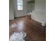 A bedroom with hardwood floors has ample natural light and a closet, and awaits personalization at 3626 N Denny St, Indianapolis, IN 46218