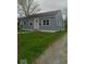 Charming single-story home with light blue siding and a well-manicured front lawn at 3626 N Denny St, Indianapolis, IN 46218