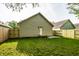 Spacious backyard with new wooden fence, garage, and a well-maintained lawn at 3818 Fetlock Dr, Indianapolis, IN 46227