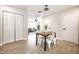 Open-concept dining area leads to a living space and features wood floors and natural light at 3818 Fetlock Dr, Indianapolis, IN 46227