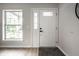 Bright entryway featuring a white front door with sidelight and window, complemented by light wood flooring at 3818 Fetlock Dr, Indianapolis, IN 46227