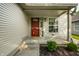 Inviting front porch features a red door and large windows, creating a warm and welcoming entrance to the home at 3818 Fetlock Dr, Indianapolis, IN 46227