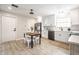 Open kitchen boasts stainless appliances, white cabinetry, and an adjacent dining area with natural light at 3818 Fetlock Dr, Indianapolis, IN 46227
