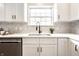 Bright kitchen features white cabinets, stainless steel appliances, and a stylish backsplash at 3818 Fetlock Dr, Indianapolis, IN 46227