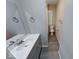 Modern bathroom boasts vanity with sink, mirror, and nearby toilet at 418 Eastern Ave, Indianapolis, IN 46201