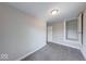 A bright bedroom featuring neutral walls, gray carpet, and a closet for ample storage at 418 Eastern Ave, Indianapolis, IN 46201