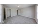 Bright bedroom featuring neutral walls, gray carpet, two windows, and a closet for storage at 418 Eastern Ave, Indianapolis, IN 46201
