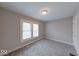 Charming bedroom with neutral walls, gray carpet, and a window, offering natural light at 418 Eastern Ave, Indianapolis, IN 46201