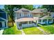 The home has a covered front porch with a well-manicured lawn and lush greenery at 418 Eastern Ave, Indianapolis, IN 46201