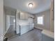 Functional kitchen with sleek gray cabinets, sink, and views to other rooms at 418 Eastern Ave, Indianapolis, IN 46201