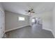 Open living area with gray floors, neutral paint, and staircase to upper level at 418 Eastern Ave, Indianapolis, IN 46201