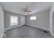 Neutral living room with modern gray flooring, ceiling fan, and abundant natural light at 418 Eastern Ave, Indianapolis, IN 46201