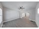 Bright living room featuring a ceiling fan and neutral paint, complemented by modern gray flooring at 418 Eastern Ave, Indianapolis, IN 46201