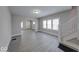 Spacious living area featuring gray floors, neutral walls, and staircase access at 418 Eastern Ave, Indianapolis, IN 46201