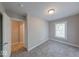 Clean bedroom features gray walls, neutral carpet, window, and closet space at 420 Eastern Ave, Indianapolis, IN 46201