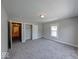A clean bedroom featuring neutral walls, new carpet, and a hallway view at 420 Eastern Ave, Indianapolis, IN 46201
