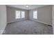 Inviting bedroom with neutral walls, new carpet, and three windows offering plenty of natural light at 420 Eastern Ave, Indianapolis, IN 46201