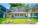 Quaint two-story home featuring a cozy front porch and beautiful green lawn at 420 Eastern Ave, Indianapolis, IN 46201