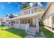 Inviting two-story home featuring a covered front porch and well-maintained landscaping at 420 Eastern Ave, Indianapolis, IN 46201