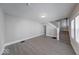 Bright living room featuring gray walls, vinyl floors, staircase, and natural light at 420 Eastern Ave, Indianapolis, IN 46201
