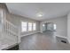 Spacious living room with gray walls, vinyl floors, staircase, and lots of natural light at 420 Eastern Ave, Indianapolis, IN 46201