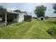 Spacious backyard with a shed, lawn, and partial view of an open field at 4363 Roosevelt Dr, Columbus, IN 47201