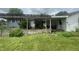 Backyard patio area with wooden pergola surrounded by green lawn and garden at 4363 Roosevelt Dr, Columbus, IN 47201