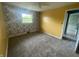 Bedroom features neutral carpet, a ceiling fan, and lots of natural light at 4363 Roosevelt Dr, Columbus, IN 47201