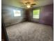 Bedroom with modern ceiling fan, carpet, and two windows for natural light at 4363 Roosevelt Dr, Columbus, IN 47201