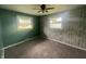 Bedroom with neutral carpet, ceiling fan, and natural light from two windows at 4363 Roosevelt Dr, Columbus, IN 47201
