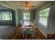 Comfortable dining room with wooden floors, a ceiling fan, and abundant natural light from two windows at 4363 Roosevelt Dr, Columbus, IN 47201