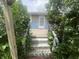 Front entrance featuring weathered wooden steps leading to a blue and tan home exterior at 4363 Roosevelt Dr, Columbus, IN 47201