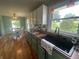 The kitchen sink area, with a view into the dining room featuring natural light and neutral decor at 4363 Roosevelt Dr, Columbus, IN 47201