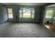 Spacious living room bathed in natural light, showcasing the flow into dining area and front door at 4363 Roosevelt Dr, Columbus, IN 47201