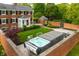 Beautiful backyard featuring a modern hot tub, manicured lawn, brick privacy wall and lovely landscaping at 4601 W Legacy Dr, Muncie, IN 47304