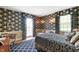 Luxurious bedroom featuring ornate wallpaper, window seat, and a plush bed at 4601 W Legacy Dr, Muncie, IN 47304
