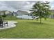 Beautiful backyard featuring a large, well-maintained lawn and a stylish concrete patio at 4925 Chip Shot Ln, Indianapolis, IN 46235