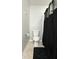 Standard toilet with a black shower curtain in a clean bathroom at 4925 Chip Shot Ln, Indianapolis, IN 46235